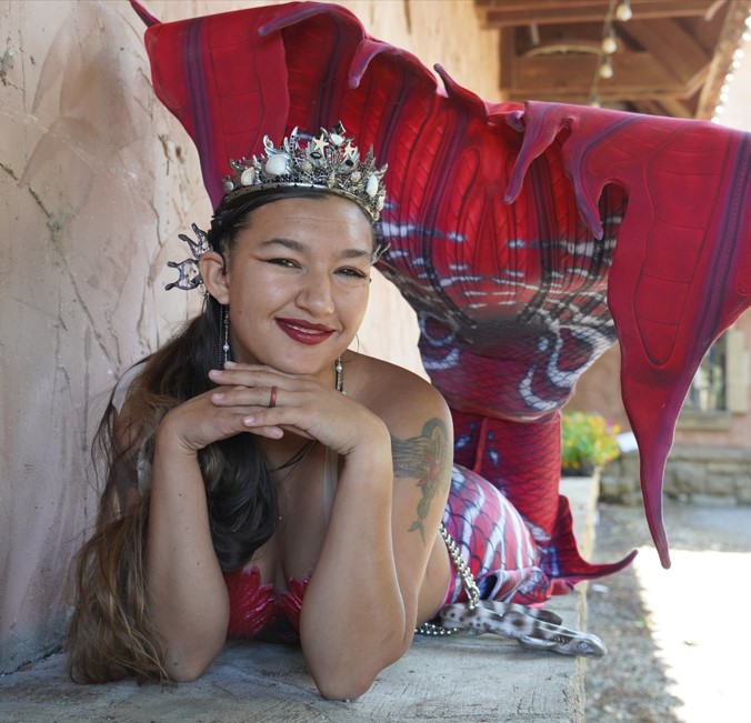 Mermaid smiling on cement stand